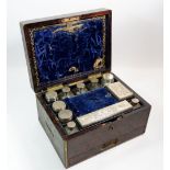 A 19th century rosewood toiletry box with silver plated and silver lidded glass toiletry jars