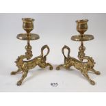 A pair of brass dragon form candlesticks, 14cm