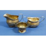 A silver milk jug, London 1882 and two silver sugar bowls, 261g total weight
