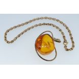 A yellow metal Russian mounted piece of amber, 3.5x 2.5cm marked 875 and a yellow metal bracelet