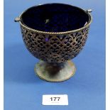 A Victorian silver pierced decorated basket bowl with handle and blue glass liner by Cartwright,
