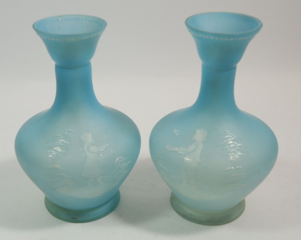 A pair of Mary Gregory style pale blue satin finish glass vases painted boy and girl holding