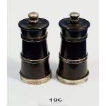 A pair of ebony and silver banded pepper grinders, 9cm