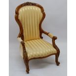 A Victorian walnut chair with carved decoration and yellow upholstery