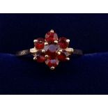 A 9 carat gold garnet cluster ring, size K