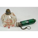 A Victorian green glass double ended scent bottle on chain and a red tinted ribbed glass scent