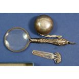 A silver yo yo, silver elephant bookmark and white metal magnifying glass