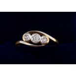 An 18 carat gold and platinum illusion set three stone diamond ring, size K to L, 1.9g