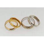 A 22 carat gold wedding band, 3.2g, an 18 carat gold wedding band, 5g and two 9 carat white gold