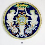 A Maiolica plate painted classical figures and mask, signed and impressed marks, 23cm diameter