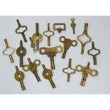 A collection of various brass clock winding keys including Popular Progress, United Clock Company