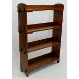 An oak Arts & Crafts pegged construction bookcase with incised numbers originally intended for an