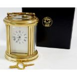 A L'Epee small brass carriage oval clock, cased, 7.5cm tall