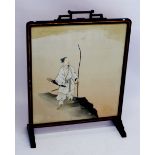 A Japanese black lacquer framed fire screen painted huntsman with bow and arrow and sword, with
