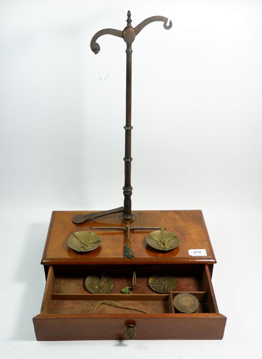 A Victorian set of brass balance scales with mahogany drawer base, 38cm wide
