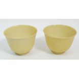 A Chinese pair of eggshell porcelain yellow cups with 'Daqing Guang Xu' mark to base, 4.5cm tall