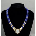 A 9 carat gold necklace set lapis lazuli panels and double strand pearls