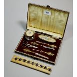 A vintage manicure set and a floral bracelet