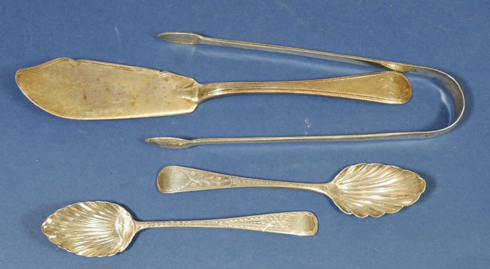 A pair of silver shell bowl teaspoons, silver sugar tongs and a silver butter knife, 116g