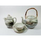 A Japanese eggshell part tea service including teapot, milk and sugar, two cups, six saucers, six