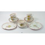 A 19th century creamware set of five cups and saucers and two oval dishes painted shell and flowers