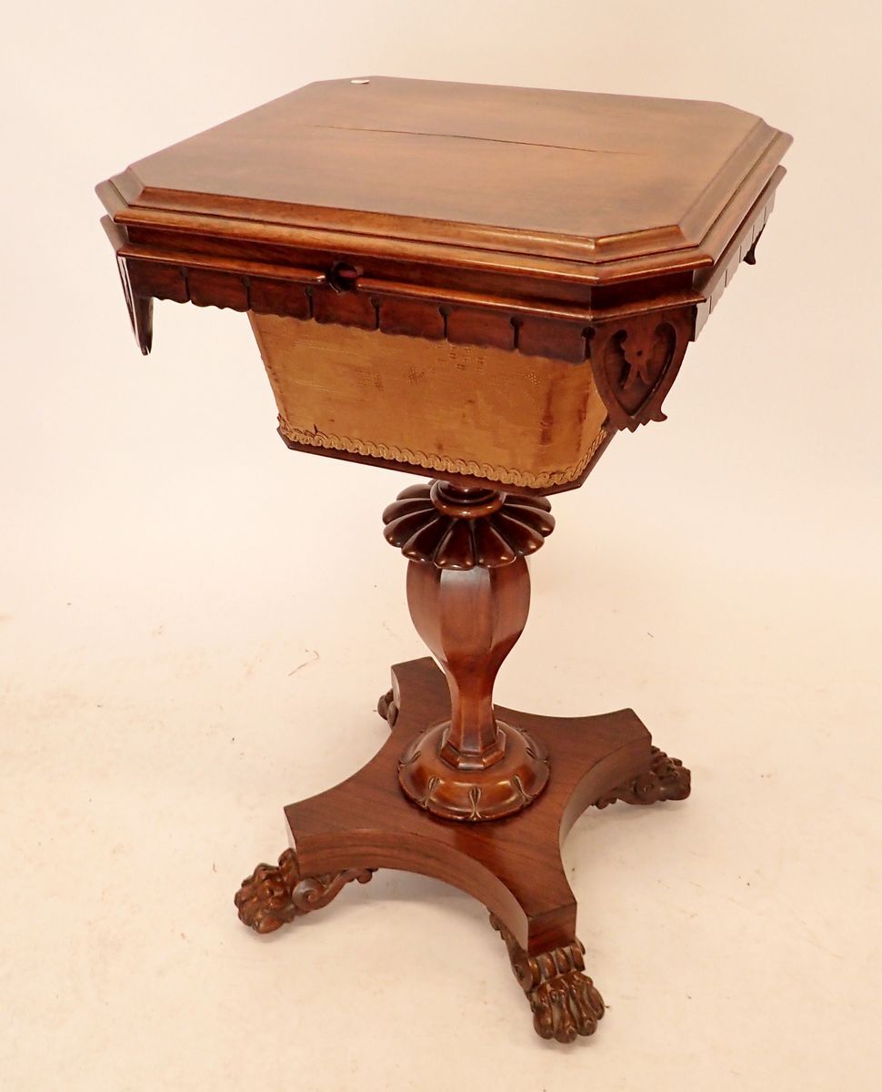 A 19th century rosewood sewing table with square top enclosing well, all on carved column and