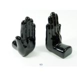 A pair of 'black hand' novelty black hand book ends, 16cm tall
