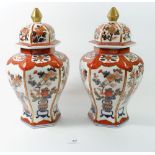 A pair of Imari style hexagonal jars and covers, 32cm high
