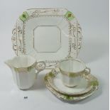 A Melba Edwardian tea service comprising six cups and saucers, six tea plates, cake plate and jug