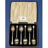 A set of six silver coffee spoons with dog nose terminals, cased, Birmingham 1941