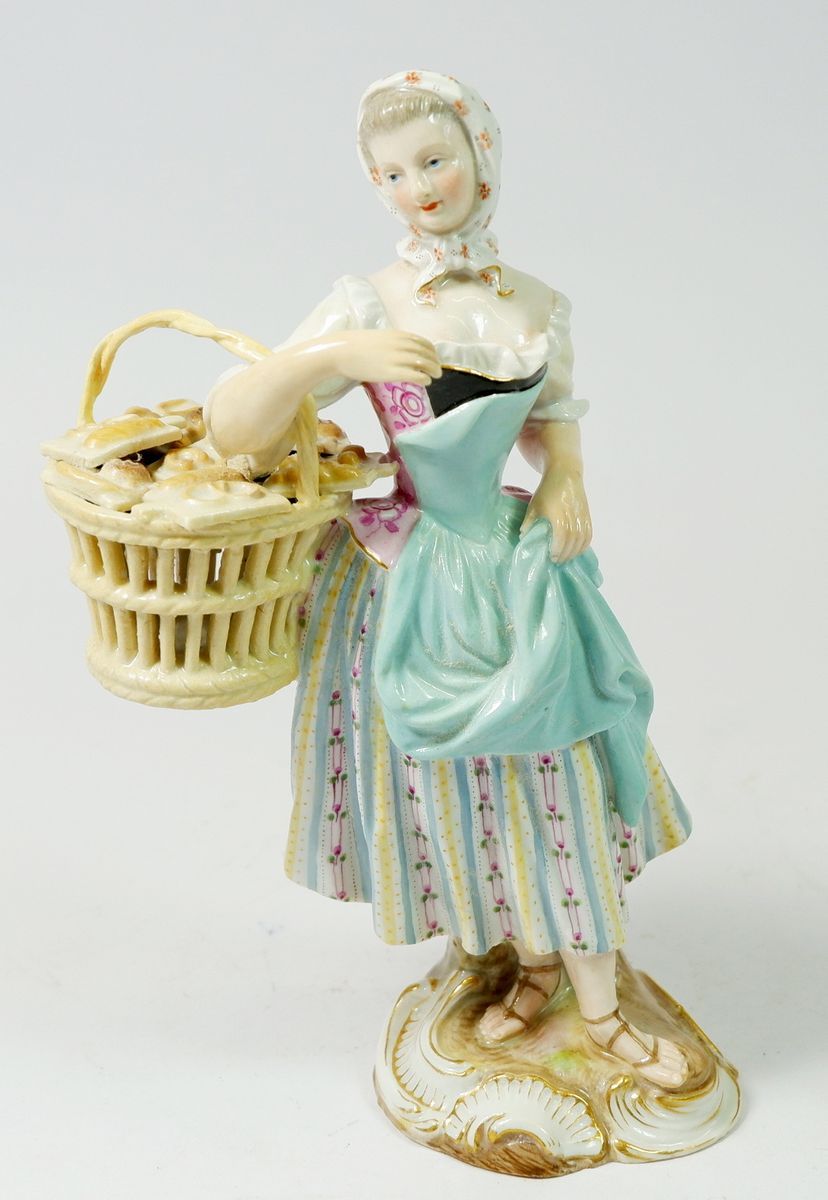 A 19th century Meissen porcelain Cris de Paris figure of a pastry seller, 19cm tall, blue crossed