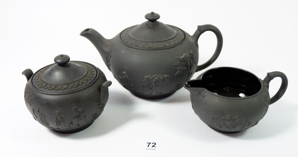 A Wedgwood black basalt three piece teaset comprising: teapot, jug and sugar