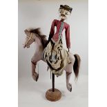 An Indian painted wood puppet on a horse, 60cm tall