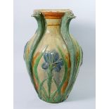 An Arts & Crafts pottery vase decorated flowers with stylised bird heads to rim, monogramed MLI,