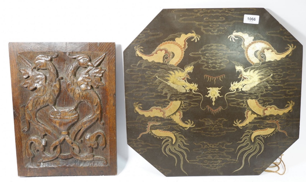 A 19th century oak panel carved two phoenix and a Chinese lacquer table top painted dragons, 46cm