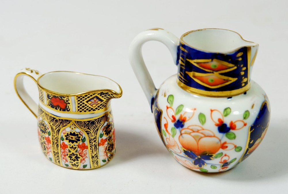 A Victorian miniature Royal Crown Derby Imari jug and a later one, pattern 1128