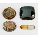 A group of Victorian stone set brooches including blood stone, fossil and agates - all set in