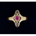 An Edwardian gold ring set red stone flanked by two old cut diamonds, size K