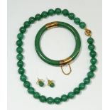 A green jade style necklace, bangle and earrings