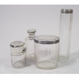 A group of four silver and glass toiletry bottles