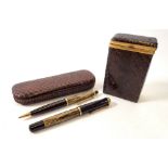 A snakeskin cigarette box and a snakeskin cased ink pen and propelling pencil