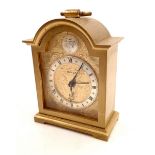 A Swiza brass arch top alarm clock, 9cm tall