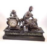 A 19th century French spelter mantel clock on marble and slate base with seated female and