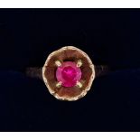 A gold ring with ruby set in circular surround, size L, marks rubbed but tested as 14 ct