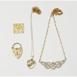 A selection of 9 carat gold jewellery to include two necklaces, and a heart shaped lock