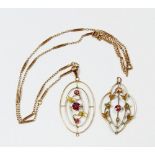 An Edwardian 9 carat gold oval pendant set amethysts and leaf decoration on 9 carat gold chain and