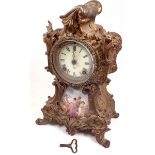A 19th century gilt metal mantel clock inset porcelain panel painted classical scene with Ansonia