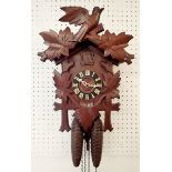 A vintage German carved Black Forest cuckoo clock with two weights and pendulum, 'Regular 812538'