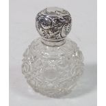 An Edwardian cut glass scent bottle with silver embossed lid, London 1914