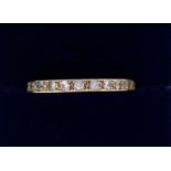 A gold eternity ring set white stones, size S to T, 2g, unmarked but tested as 9ct gold